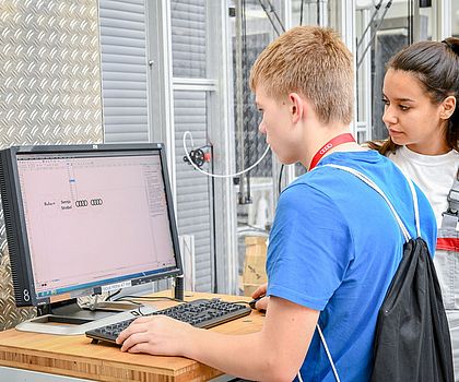 zwei Jugendliche programmieren