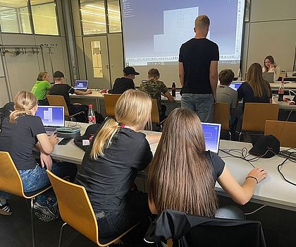 Jugendliche sitzen vor Laptops und konstruieren mit CAD